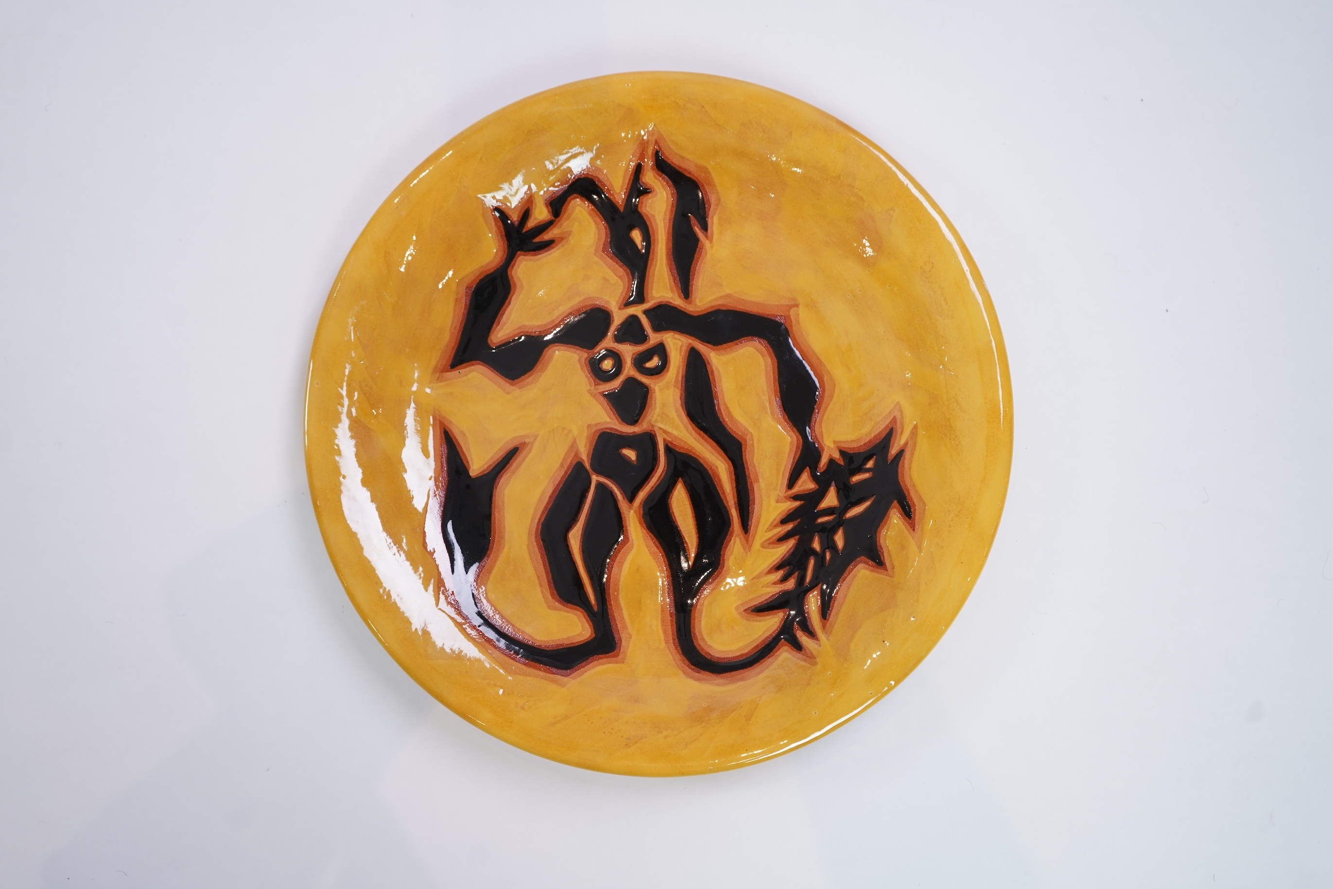 Jean Lurçat (1892-1966): A yellow glazed earthenware plate, decorated with a stylised central figure